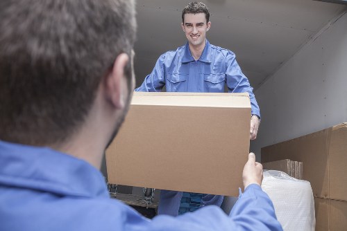 Professional movers packing household items for a Greenwich move