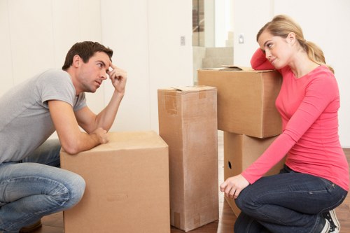 Professional movers handling furniture in a Greenwich house removal